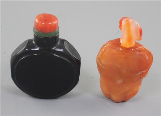 A Chinese chalcedony fruit form snuff bottle and a Chinese black glass watch-shaped snuff bottle